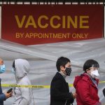 People with appointments stand in line to receive the COVID-19 vaccine at a vaccination site at Lincoln Park in East Los Angeles amid eased lockdown restrictions on January 28, 2021 in Los Angeles, California.