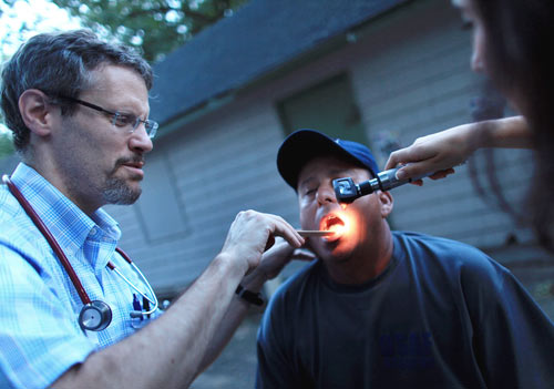 A migrant worker has his teeth examined.