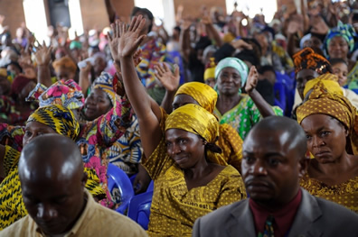 A Congolese woman raises her hand in a service for peace in the Democratic Republic of the Congo