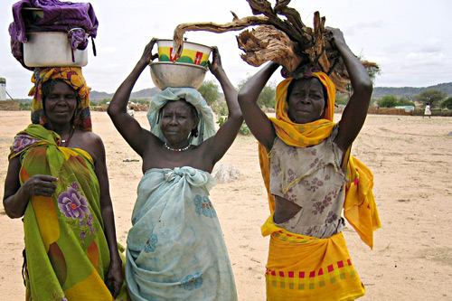 Darfuri women in Chad, carrying firewood and water