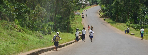 School children walk on a paved road in Kavumu. | PHR Photo