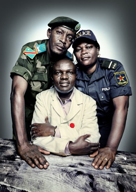 Captain David Kazadi Nzengu (standing left), a military prosecutor; Dr. Désiré Alumeti (seated), a pediatric surgeon at Panzi Hospital; and Uvoya Fwaling Honorata (standing right), an officer in the Congolese police’s Women and Child Protection Unit. All three trained in best forensic practices with PHR. | Platon for The People’s Portfolio